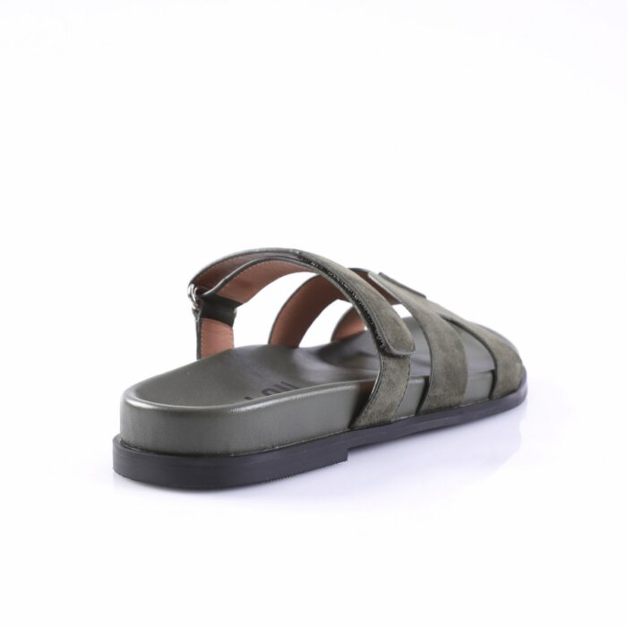 Olive green suede sandal with multiple straps and a flat black sole, shown from a rear-side angle.