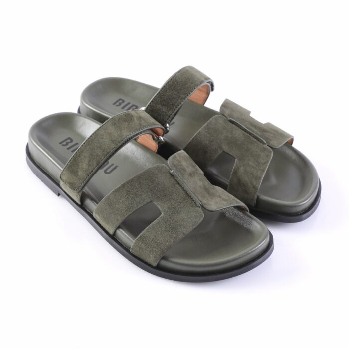 Olive green suede slide sandals with two wide straps across the foot and a black sole on a white background
