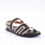 Open-toe, brown and cream crocheted strappy sandal with a black sole on a white background.
