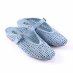 Light blue perforated suede Mary Jane sandals with an adjustable buckle strap and low brown sole