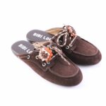Brown suede mule slippers with plaid laces and brown/orange fabric flower embellishments, shown from a side angle.
