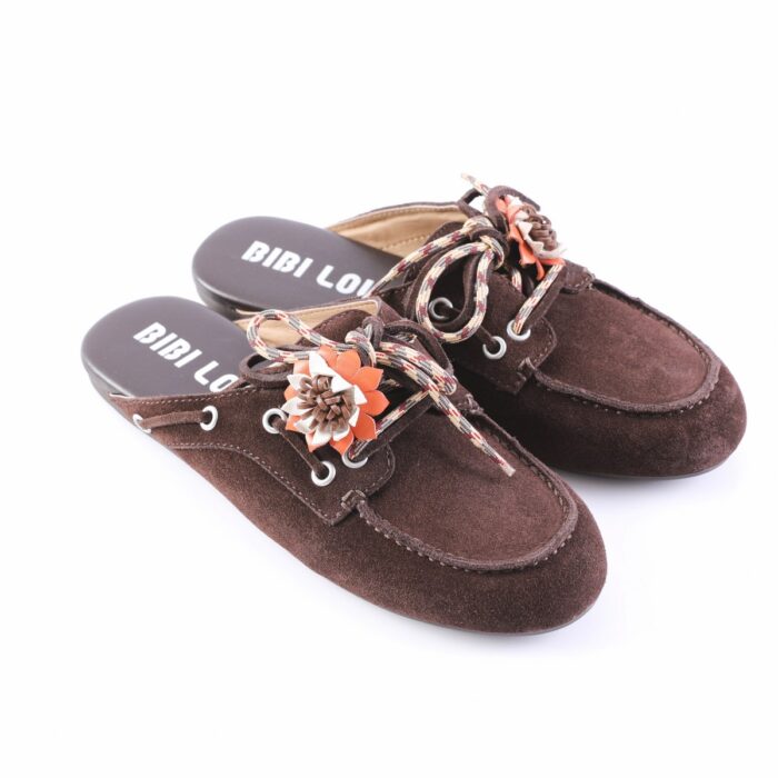 Brown suede mule slippers with plaid laces and brown/orange fabric flower embellishments, shown from a side angle.