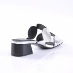 Silver metallic strappy sandal with a chunky black heel, shown on a white background from a side angle.