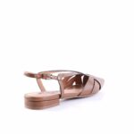 Brown strappy flat sandal with ankle buckle and low block heel on a white background.