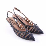 Blue strappy slingback heels with pointed toes and a low heel, featuring multiple navy straps and a tan insole with 'BIBI LOU' logo