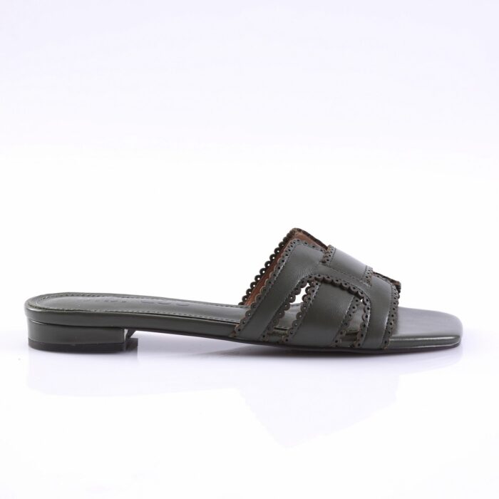 Dark green slide sandal with two wide straps featuring scalloped edges and small cutouts, flat sole.