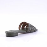 Grey slide sandal with braided straps and low block heel lying on a white surface, side view showing open toe design