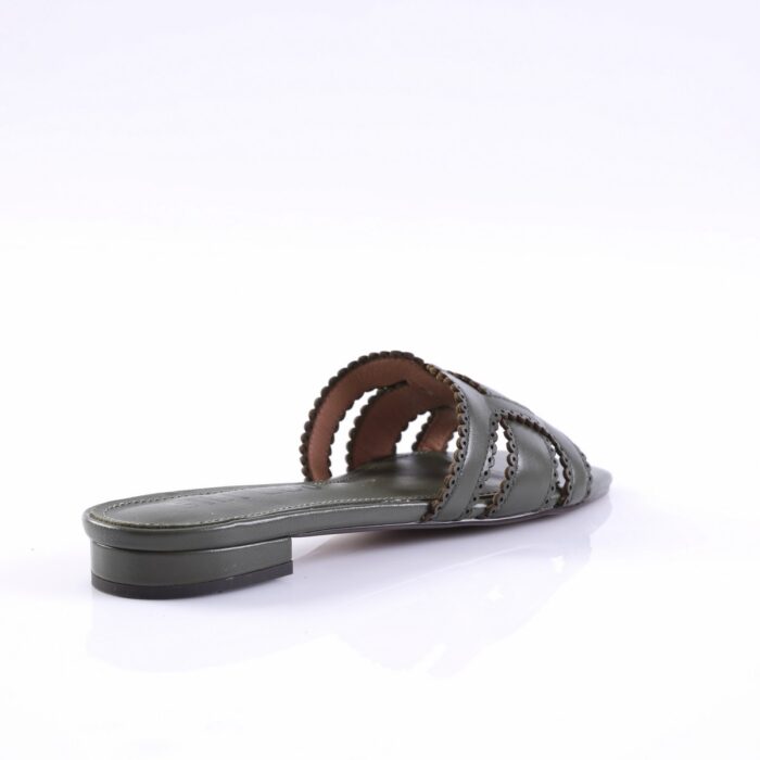 Grey slide sandal with braided straps and low block heel lying on a white surface, side view showing open toe design