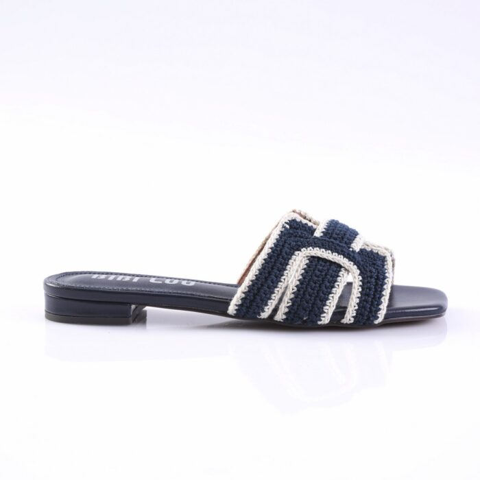 Navy blue crocheted slide sandal with white trim and a low heel, shown from the side.