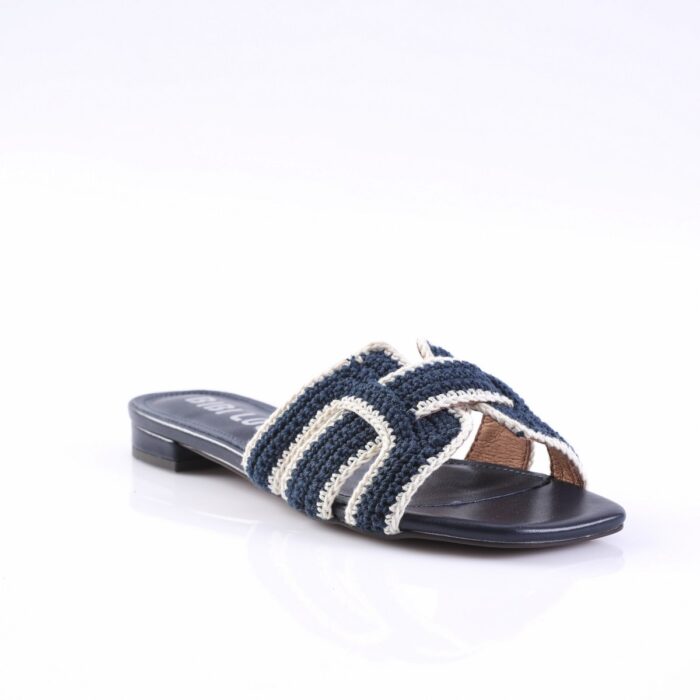 Navy blue crochet strap sandal with white trim, open toe, flat sole on a white background
