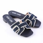 Navy blue woven slide sandals with cream trim and the brand BIBI LOU on the insole.
