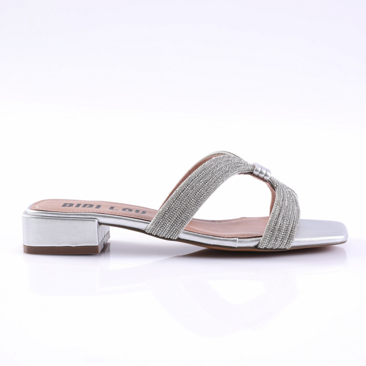 26NVM939SL-1 Silver women's sandal with a low block heel and glittery braided straps, revealing a soft pink insole and metallic sole detail.