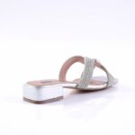 Silver sandal with rhinestone-studded straps and a low metallic block heel, viewed from the side.