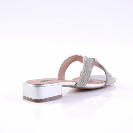 Silver sandal with rhinestone-studded straps and a low metallic block heel, viewed from the side.