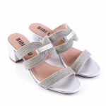 Silver glitter sandals with braided straps and low block heel, labeled BIBI LUX on the insole start side.