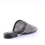 Black slide sandal covered in metallic studs with an open back and flat sole.