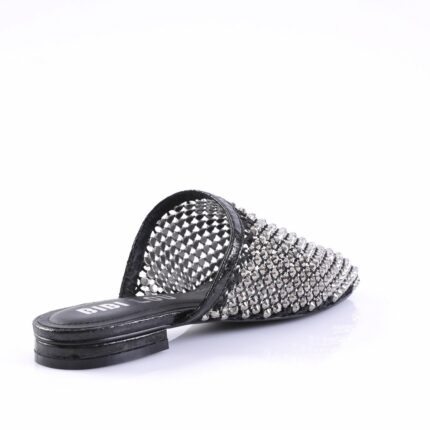 Black slide sandal covered in metallic studs with an open back and flat sole.