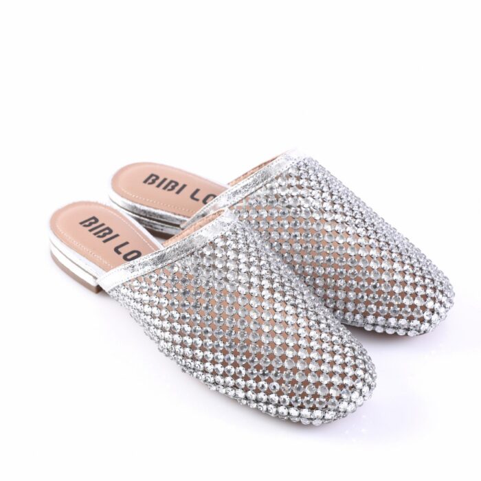 Silver rhinestone-covered slip-on sandals with a low stacked heel and beige footbeds marked BIBI LOU