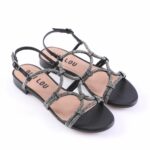 Black strappy sandals with glittery silver straps, open toe, and low heel with an ankle buckle, stylish and dressy.