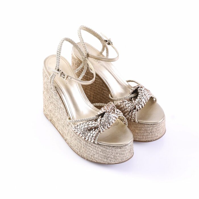 Gold metallic braided wedge sandals with ankle straps and braided front knot on a platform espadrille heel
