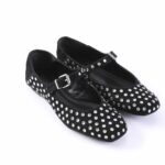 Black suede Mary Jane flats covered in silver studs with ankle straps and buckles.