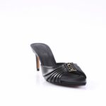 Black high-heeled mule with a pleated leather strap and gold logo hardware on the upper.