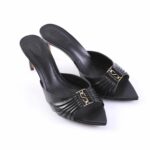 Black leather mule heels with a ruched front and gold decorative buckle, pointed toe, mid-height stiletto.