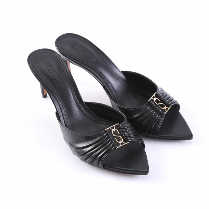 Black leather mule heels with a ruched front and gold decorative buckle, pointed toe, mid-height stiletto.