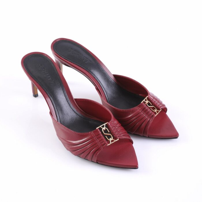 Red slip-on high-heeled mules with a pleated vamp and gold-tone buckle detail on a black insole.