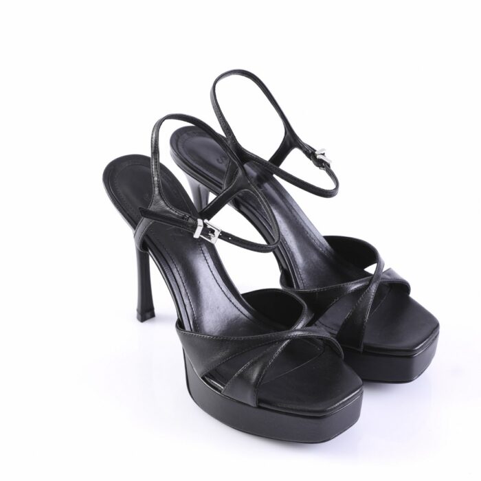 Black platform sandals with slim ankle straps and high stiletto heels, photographed on white background