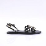 Black leather sandal with multiple studded straps and a small gold buckle on the ankle strapli