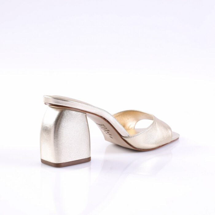 Gold metallic open-toe sandal with a short block heel on a white studio background