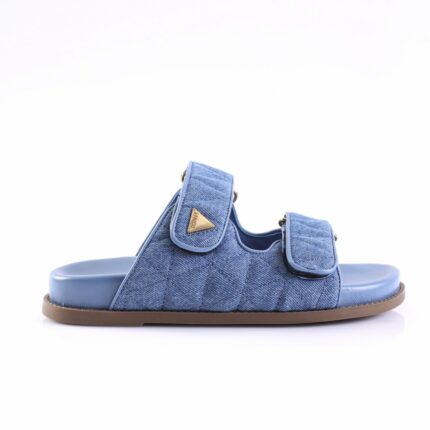 Blue denim slide sandals with two adjustable straps and a brown outsole on a white background