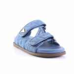 Blue denim sandal with two Velcro straps and a light brown sole on a white background.