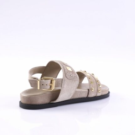 Beige suede sandal with gold studs and a gold buckle, side view, on a light background