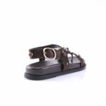 Brown suede sandal with a gold buckle and bead embellishments along the strap
