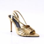 Gold metallic high-heeled sandal with ankle strap and decorative front pleats, open toe