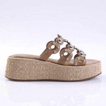 Tan leather platform sandal with a braided jute wedge heel and studded straps, designed for women.