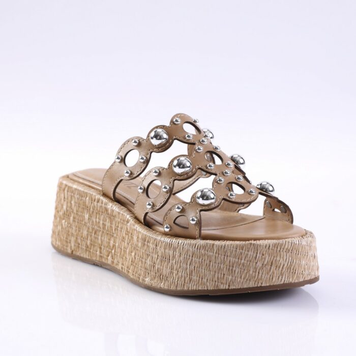 Beige platform sandal with a woven espadrille-style sole and decorative metal studs on the straps.