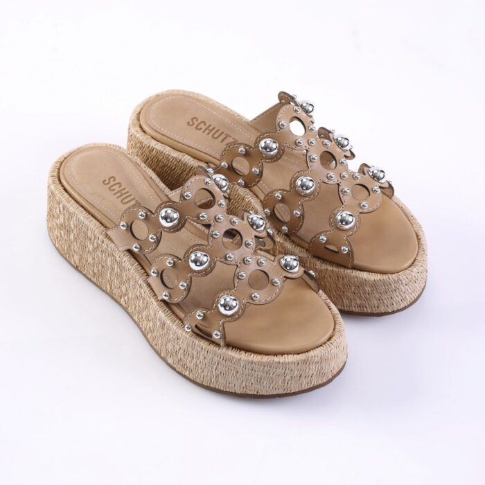 Beige platform sandals with rope-wrapped wedge and decorative silver studs across the straps, labeled SCHUTZ on the insole