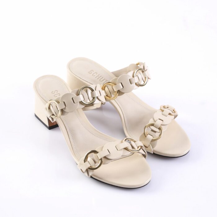 Beige open-toe heeled sandals with circular metal chain links along the straps and a low block heel.