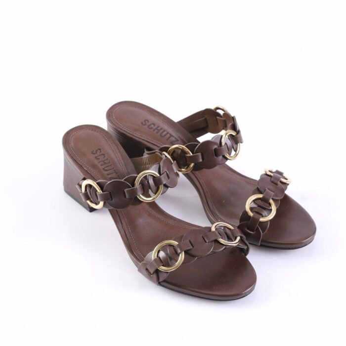 Brown leather sandals with gold-tone ring-linked straps and a low block heel.