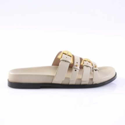 Beige slide sandal with four straps and gold buckles on a black sole.