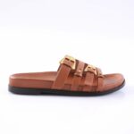 Brown slide sandal with three leather straps and gold buckles on a black sole, shown in profile.
