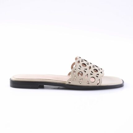 Beige women's slide sandal with a perforated geometric cutout strap and black outsole on a light insole.