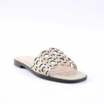 Beige open-toe slide sandal with an intricate cutout pattern and a black sole