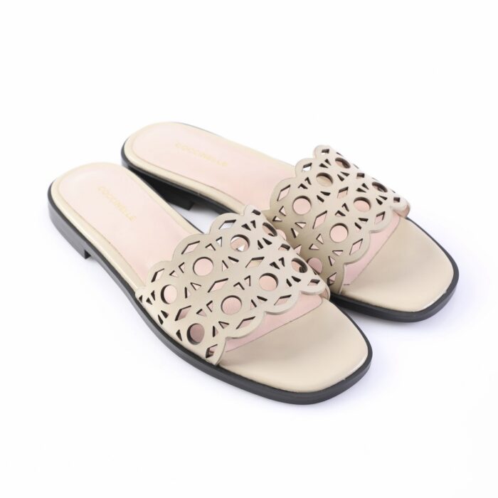Beige cutout slide sandals with scalloped patterned strap and black sole, brand visible on insole (Coccinelle).