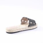 Black cut-out strap slide sandal with a woven jute midsole and ribbon-stitch edge. Suitable for warm weather outfits and casual wear.