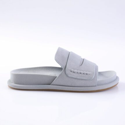 Light gray suede slide sandal with a wide Velcro strap and a light brown sole, shown from the side.