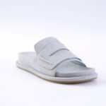 Light gray suede slide sandal with two overlapping straps and a padded sole on a light background, product photo